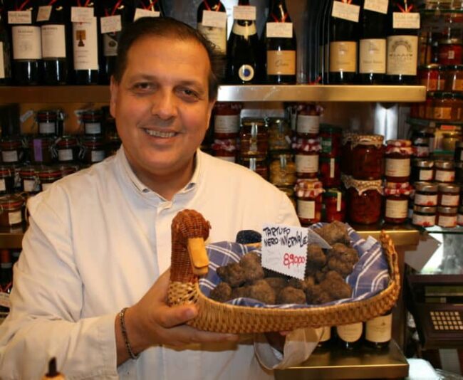 Roberto Persiani holding black truffles in E Volpetti. Yes, those are priced at 890 euros a kilo.