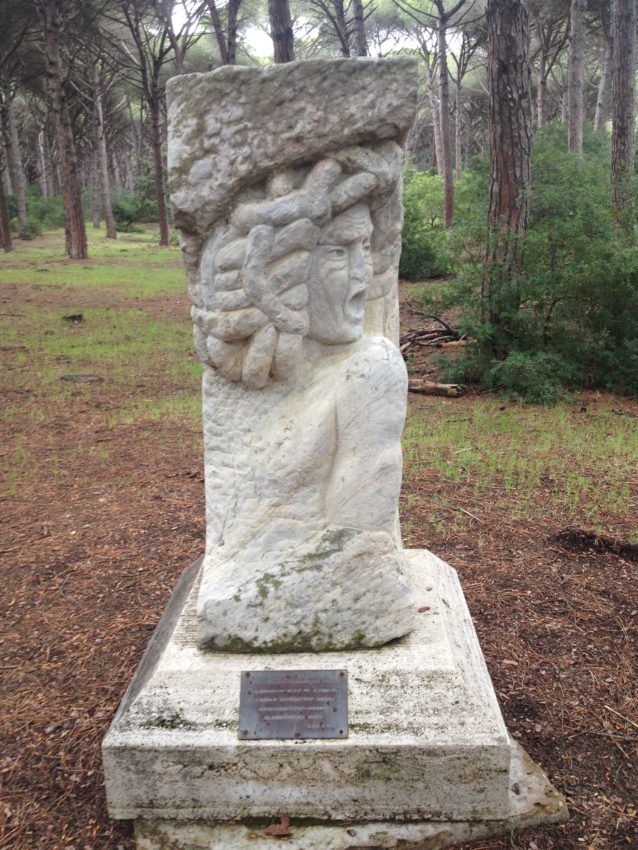 The plaque of Caravaggio in the pine forest.