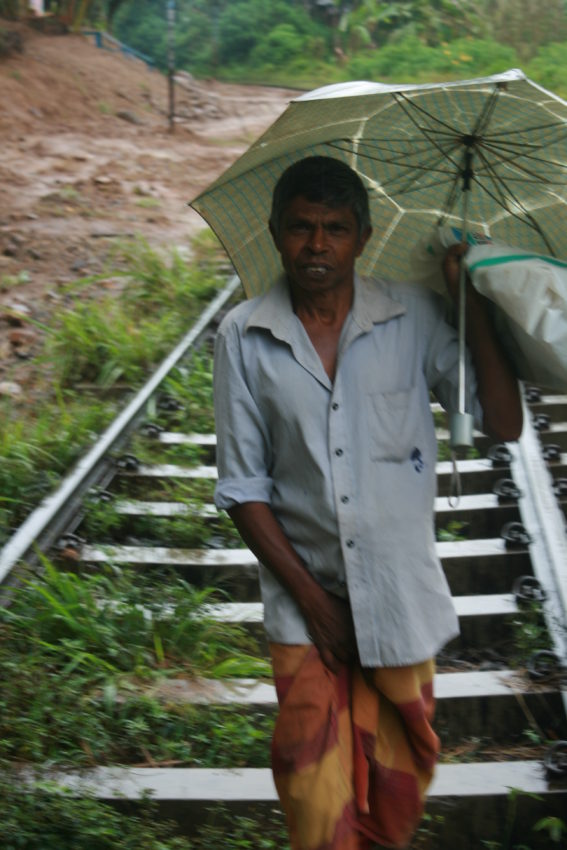 Some Sri Lankans use the railroad track as other means of transportation.