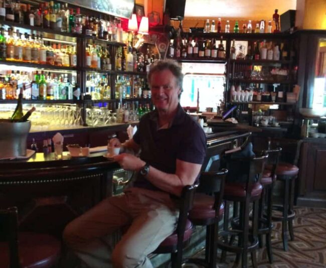 Me in Ernest Hemingway's designated seat at Closerie des Lilas in Paris' Montparnasse district.