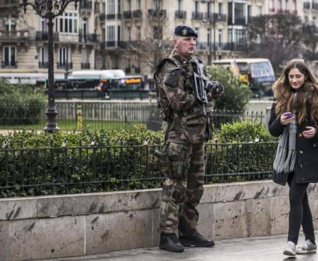 Security in Paris remains tight around the sites of the November terrorist attacks such as this soldier in front of Bataclan theater.