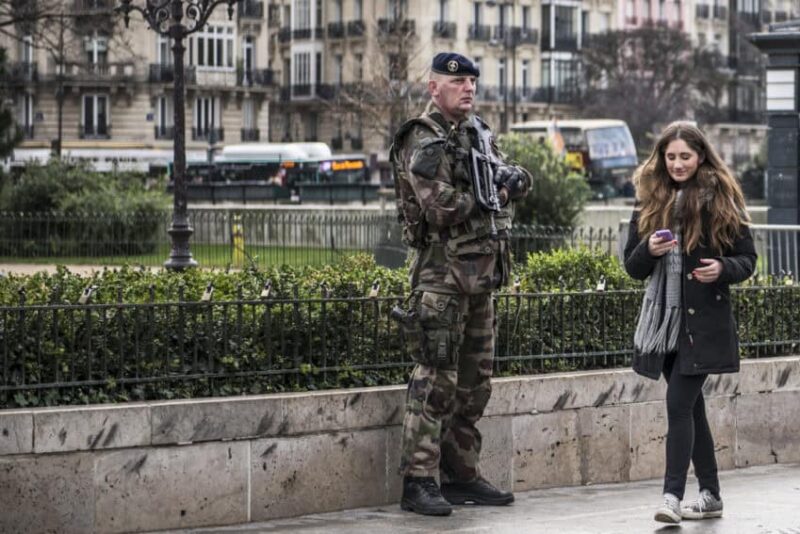 Security in Paris remains tight around the sites of the November terrorist attacks such as this soldier in front of Bataclan theater.