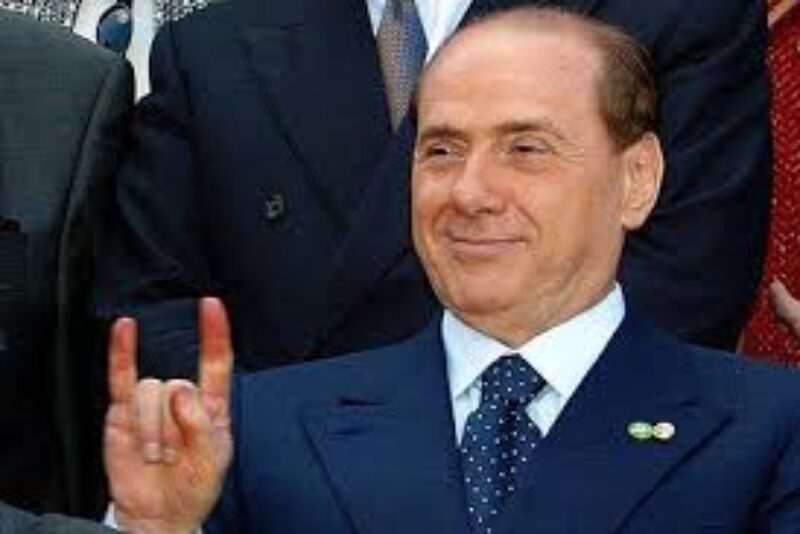 Silvio Berlusconi giving the Italian gesture for cheating.
