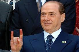 Silvio Berlusconi giving the Italian gesture for betrayal.