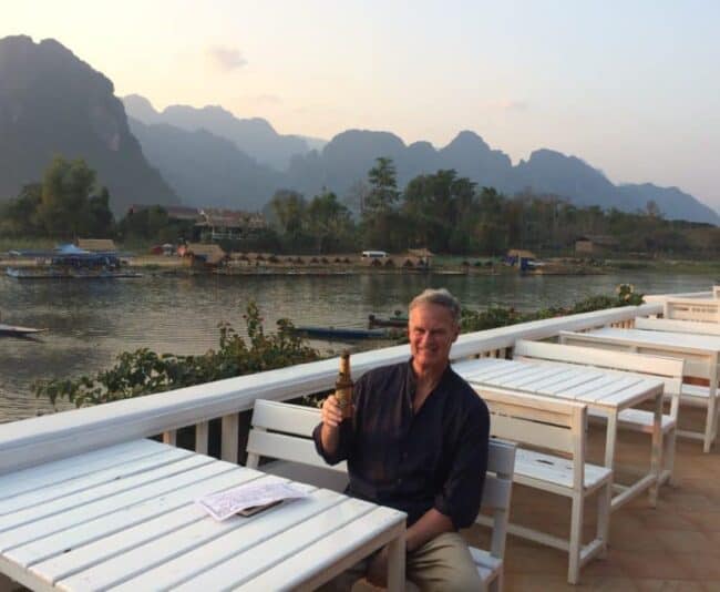 Me at my hotel on the banks of the Nam Song with Laos' towering karsts in the background.