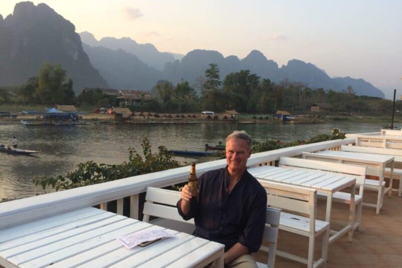 Me at my hotel on the banks of the Nam Song with Laos' towering karsts in the background.