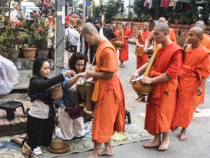 Tak Bat, giving of alms, to Buddhist monks.
