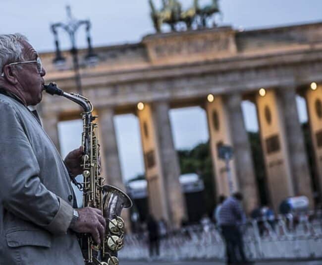 One of the many musicians in front of Brandenburg Gate, once the symbol of East-West division and now one of top attractions to 12 million visitors a year. Photo by Marina Pascucci