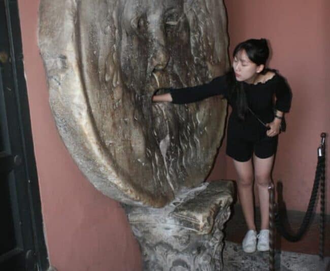 Tourists stand in line for ever to put their arm in the Bocca della Verita'.