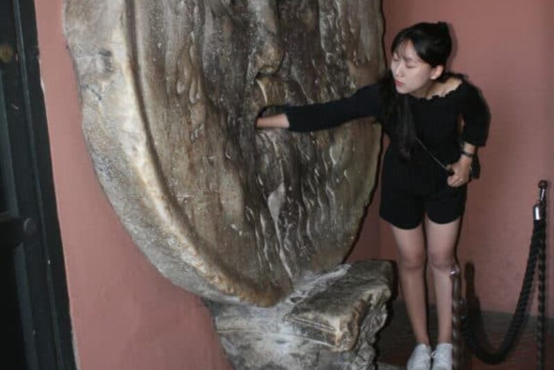 Tourists stand in line for ever to put their arm in the Bocca della Verita'.