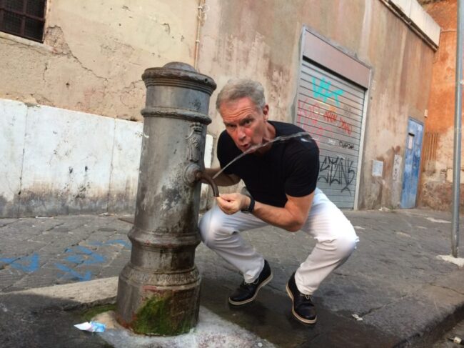 Me at one of the "nasone" in steaming Rome. The city has 2,500 of them but the water shortage has closed 400 of them.