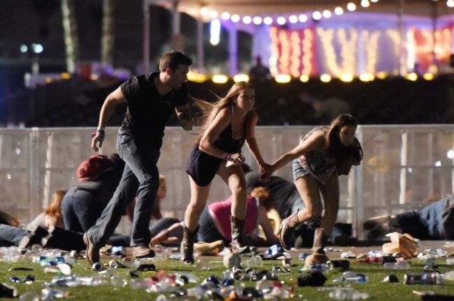 Concert goers run for cover Sunday night in Las Vegas where a gunman killed 59 people and injured more than 500.