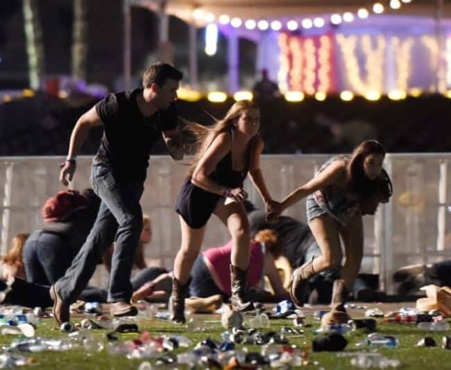 Concert goers run for cover Sunday night in Las Vegas where a gunman killed 59 people and injured more than 500.