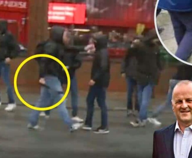 A hammer-wielding Roma fan approaches Liverpool fans April 24 in Liverpool. An attack left Liverpool fan Sean Cox in a coma. Times of London photo