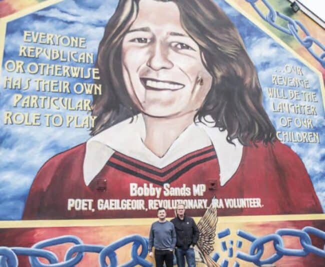 Patrick O'Byrne and I in front of the Bobby Sands mural on Belfast's Falls Road. Photo by Marina Pascucci