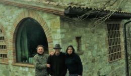 Fabrizio Bizzarri, Ev Thomas and Claudia Rizza stand in front of Thomas' and Rizza's 800-year-old house in Umbria.