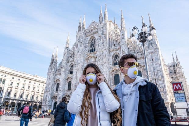 People wearing masks in Milan against the coronavirus.