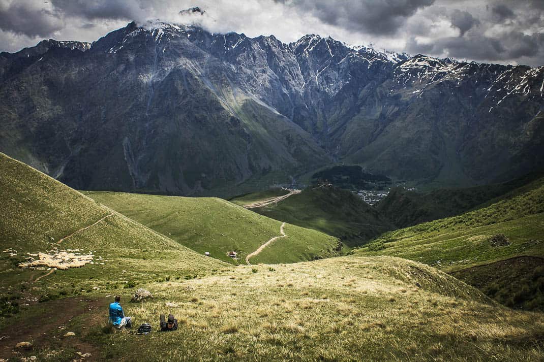 A lone hiker high above Trinity Church in the Republic of Georgia's Caucasus Mountains.