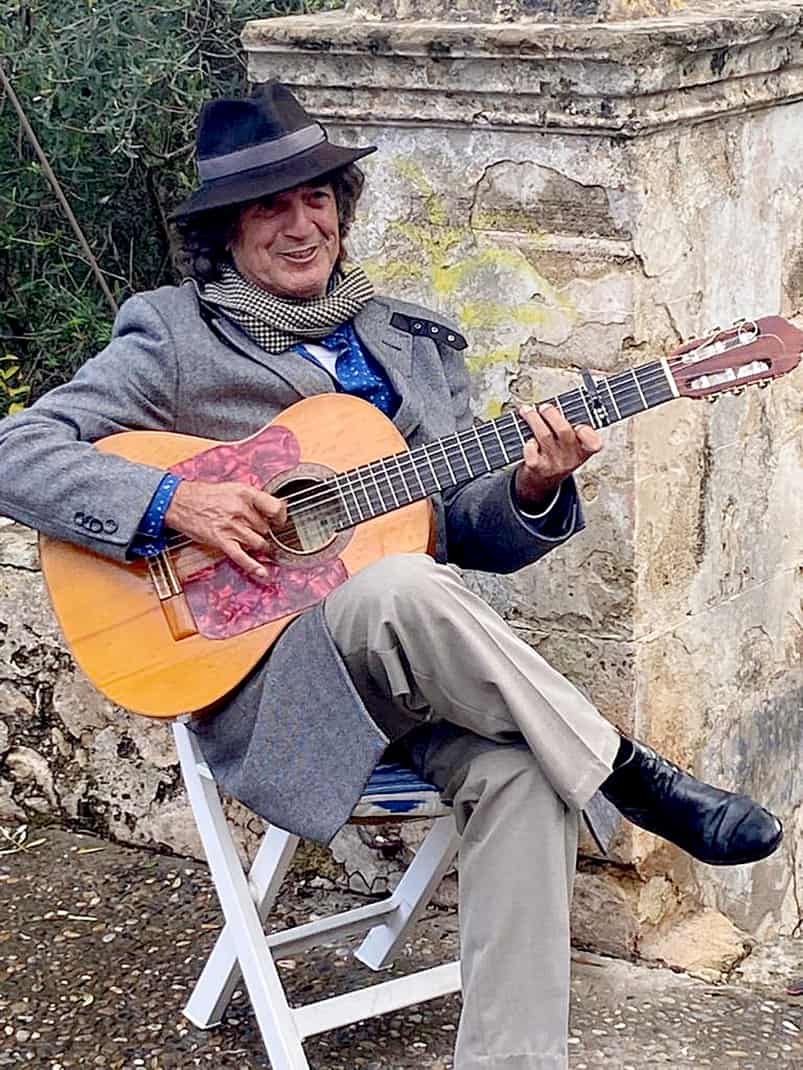 A Mallorcan plays the guitar outside Calvary Chapel.