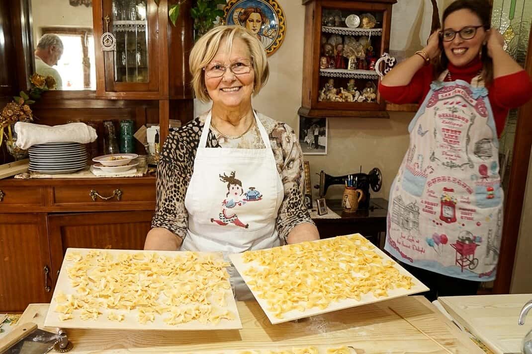 Angela Curci shows off her class' homemade pasta with NonnaLive co-owner Chiara Leone to her left.