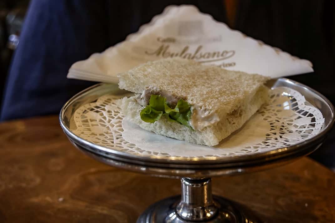 The tramezzino is presented on, literally, a silver platter at Cafe Mulassano.