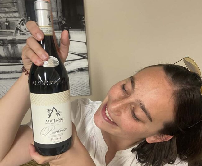 Michele Adriano lovingly looks at her Barolo wine at the Go Wine event in Rome.